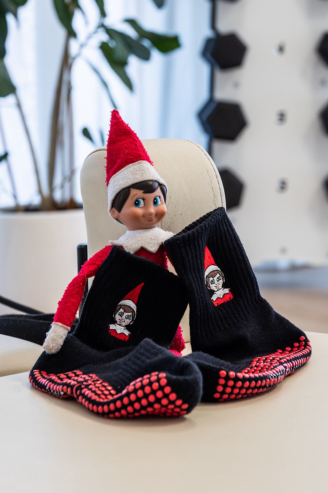 The Elf on the Shelf with black socks featuring red grip for Christmas