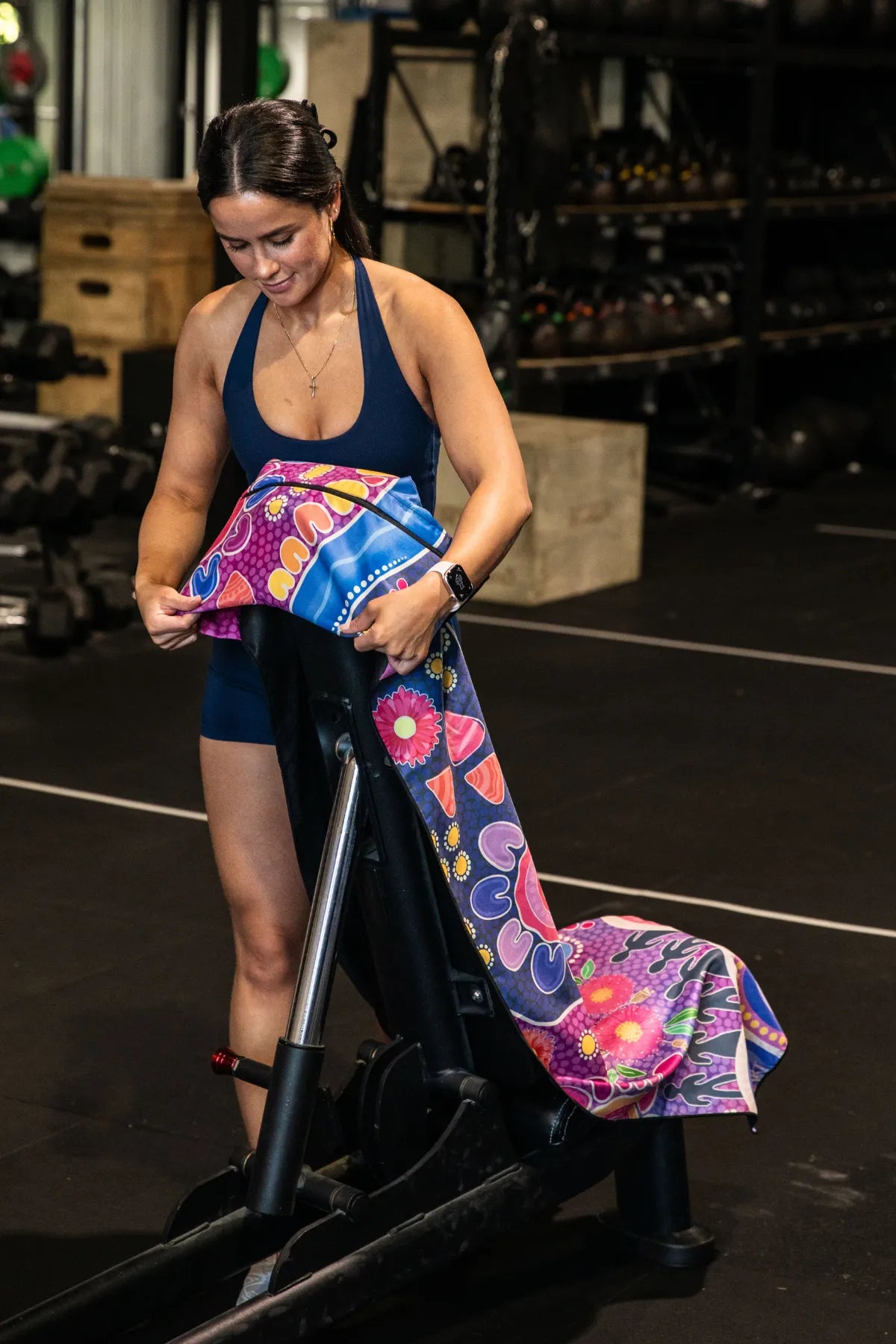 Thriving Together Indigenous hooded gym towel by Aboriginal artist Mirii Art featuring vibrant colours, 140x60cm with zip pocket in hood, stays on gym bench, quick-dry and odour resistant by Cheeky Winx Australia.