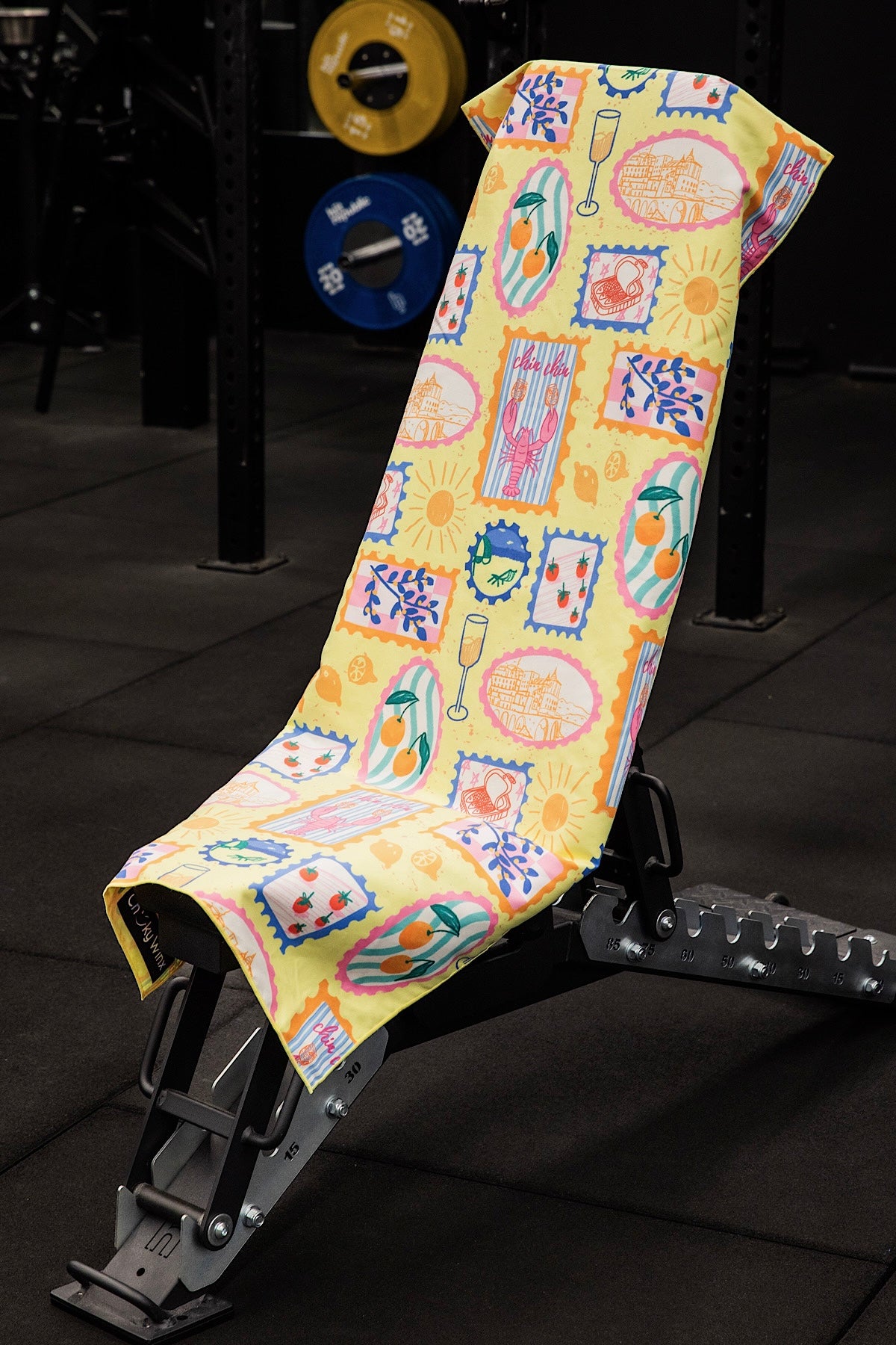 Colorful towel with pattern on a weight bench in a gym setting
