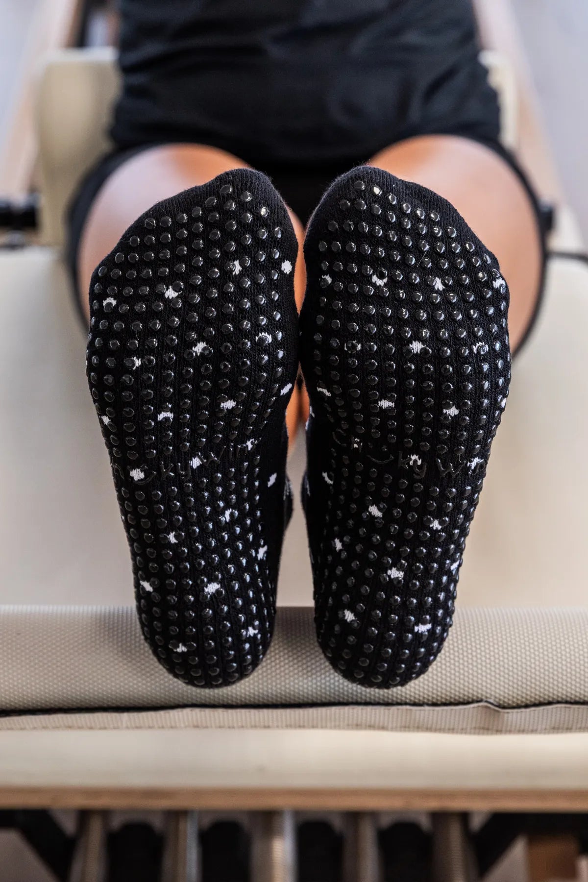 Black ankle grip socks with white spots and non-slip sole for reformer, Pilates, yoga, and barre by Cheeky Winx. Australia's best grip socks.