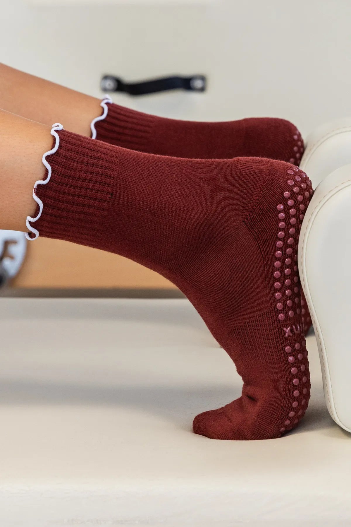 Maroon frilly grip socks with decorative frill and non-slip sole for reformer, Pilates, yoga, and barre by Cheeky Winx. Australia's best grip socks.